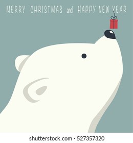 The cover design. Depicts face little polar bear with gift box. Phrase merry Christmas and a happy New year on blue background.