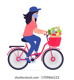 COVID-19. Coronavirus epidemic. Safe food delivery. Courier girl in a protective mask delivers food on a bicycle