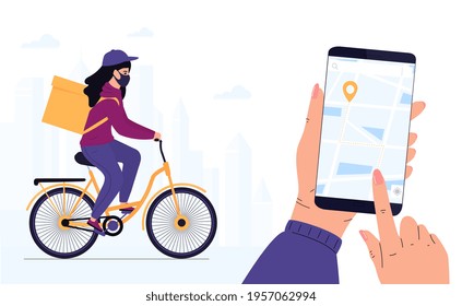 COVID-19. Quarantine. Coronavirus epidemic. Delivery woman in a protective mask delivers parcel by bike. Track shipments using the mobile application. Hand is holding smartphone.