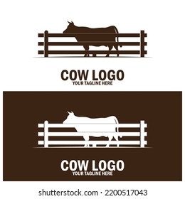 cow silhouette behind wooden fence paddock for vintage retro rustic countryside western country farm ranch logo design