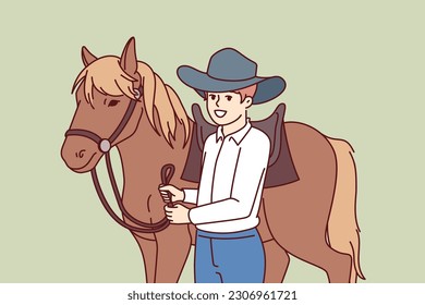 Cowboy boy is standing next to horse caring for stallion and wanting to become professional jockey and race. Schoolboy wearing texas ranger hat near horse for ride or competition at racetrack