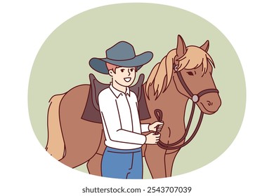 Cowboy boy is standing next to horse caring for stallion and wanting to become professional jockey and race. Schoolboy wearing texas ranger hat near horse for ride or competition at racetrack