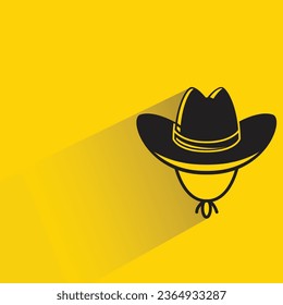 cowboy hat with shadow on yellow background