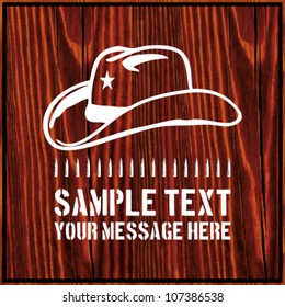 Cowboy hat with a star and an ammo belt on wooden background with text