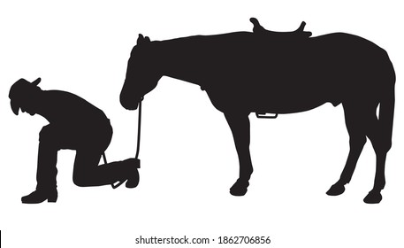 A cowboy is kneeling and studying the ground while his horse waits