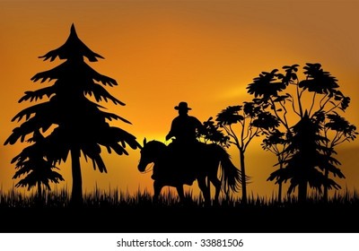 Cowboy on a horse over sunset