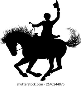 A cowboy riding a horse in silhouette waving hat in the air