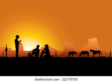 Cowboys resting at sunset