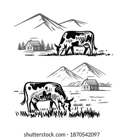 cows eat grass in village against background of mountains