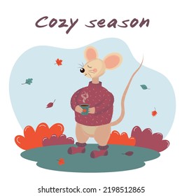 Cozy autumn card with mouse in warm sweater holding hot coffee mug. Cozy season text. Autumn mood. Greeting card or poster.