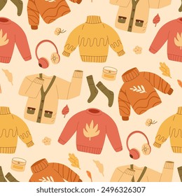 Cozy autumn clothes seamless pattern. Sweaters and headphones endless background. Fall repeat cover. Vector hand drawn flat illustration.