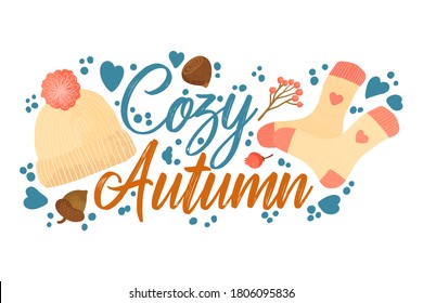 Cozy Autumn - Fall typography quotes with autumns elements. Vector quotes with autumns knitted socks, forest nuts, berries and knitted hat with pompon. Isolated on white background. 