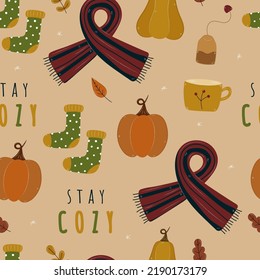 Cozy autumn seamless pattern with pumpkins, scarves, socks, seasonal leaves. Thanksgiving hand drawn textile print. Vector stay cozy background