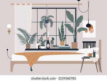 A cozy bedroom interior, books and candles on the windowsill, green plants everywhere