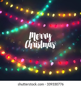 Cozy colorful Christmas lights garlands, greeting card with Merry Christmas typography