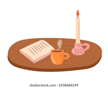 Composición acogedora con un libro, taza de té y vela. Escena de lectura aislada.