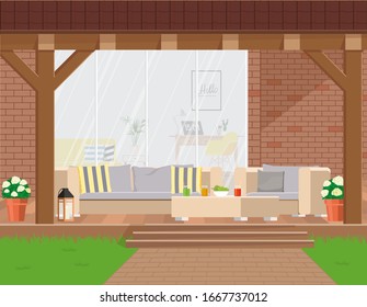 Cozy garden corner with outdoor furniture under a canopy against the backdrop of a panoramic window.