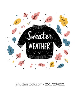 Eine gemütliche handgezeichnete Illustration mit dem Ausdruck 'Sweater Weather' mit einem schwarzen Pullover, umgeben von bunten Herbstblättern, die den Herbst und seine gemütliche Stimmung feiern