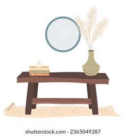 Cozy home. Bench in a hallway with pile of books, lighted candle and vase with dried pampas grass bouquet. Cozy autumn days concept.