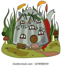 A cozy little house in a teapot in the grass