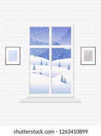 Cozy room with a window and a view of the winter landscape: mountains, snowdrifts, trees, deer, snow falls. 