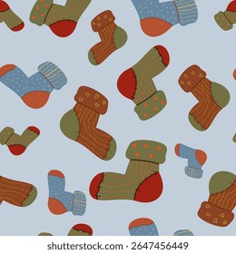 Cozy seamless pattern of warm handmade socks on a light blue background. Perfect for wrapping paper, digital backgrounds, and comfort-themed seasonal designs.