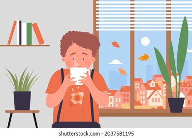 Cozy time at home, kid with tea or chocolate mug vector illustration. Cartoon boy child character holding hot tea cup in hands, drinking warming drink by window with autumn city landscape background