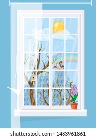 A cozy window with a spring landscape with hyacinth on the windowsill.