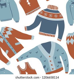 Cozy winter seamless pattern. Vector background of cute winter clothes: sweaters, socks, hats, scarf. Hand draw texture with sweaters with norwegian ornaments. New Year and winter holiday symbols