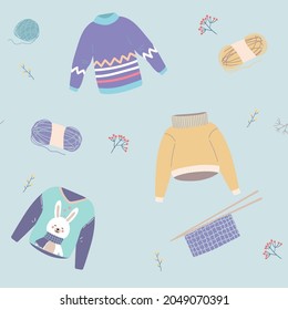 Cozy winter sweaters. Hand drawn colored vector seamless pattern. Blue background Cute winter warm knitted clothes . Wool knitting winter clothes, knitting sweaters