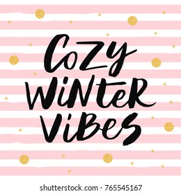 Cozy winter vibes - trendy brush hand lettering. Background with pink stripes and gold glitter circles. Greeting card for the winter season. Vector illustration.