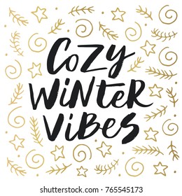 Cozy winter vibes - trendy brush hand lettering with gold holiday elements. Greeting card for the winter season. Vector illustration.