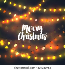 Cozy yellow Christmas lights garlands, greeting card with Merry Christmas typography