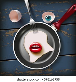 cracked raw egg with red lips and eye on frying pan with fork on the old wood table