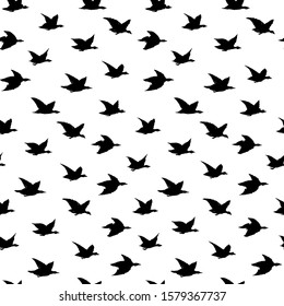 Crane Birds Japanese Seamless Pattern with Simple Birds Silhouettes for wallpapers, backdrops or fabric textile. Flying elegant black swallows, hand-drawn ink illustration on white blackground