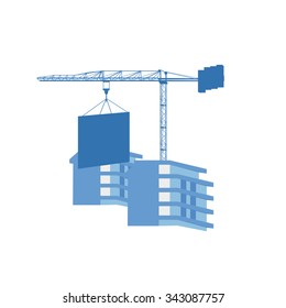 Crane and hanging load under the two new buildings at the construction site  