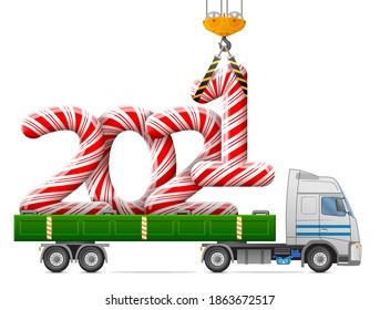 Crane loads New Year 2021 of candy stick. Big striped holiday candies year number in back of truck