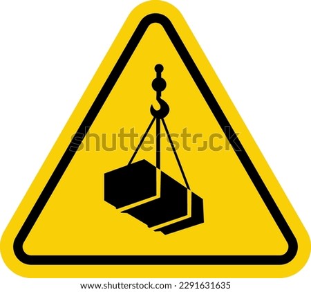 Crane sign. Crane warning sign with suspended load. Yellow triangle sign with a crate attached to a hook inside. Caution crane, stay clear of suspended loads. Loading cargo. Overhead crane.