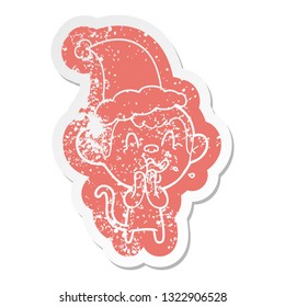 crazy quirky cartoon distressed sticker of a monkey wearing santa hat