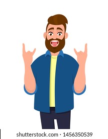 Crazy young man gesturing, doing or making rock sign with hands up with funny expression. Rejoicing delightful guy demonstrating tongue out. Modern lifestyle, human face emotion concept in cartoon.