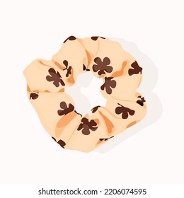 A cream scrunchie that is in the shape of a circle, as well as a scrunchie. 