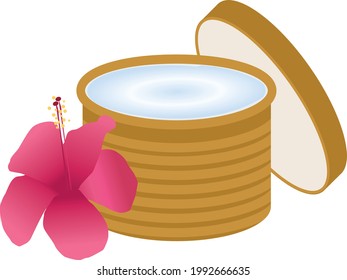 cream in a wooden jar with an exotic flower