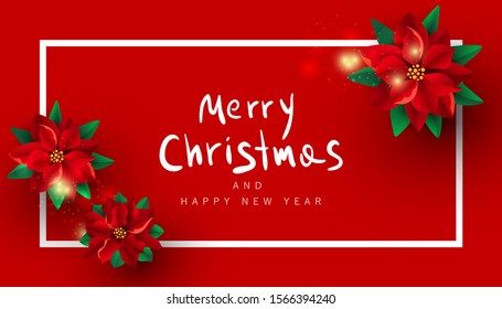 Creative background with red poinsettia flowers and a white frame on a red burgundy background with copy space.