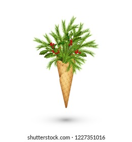 Creative Christmas composition in a waffle cone of coniferous branches, holly and berries on white background