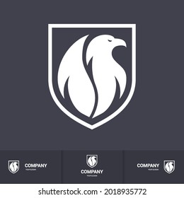 Creative Eagle Logo Inside Shield. Concept Inspiration Template. Modern Professional Hawk Logo Design. Phoenix Head Logo Illustration on Dark Backdrop