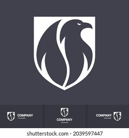 Creative Eagle Logo Inside Shield. Concept Inspiration Template. Modern Professional Hawk Logo Design. Phoenix Head Logo Illustration on Dark Background