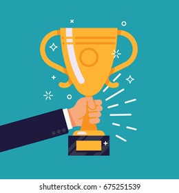 Creative Flat Design Vector Concept On Businessman Hand Holding Gold Cup Award Icon. Winner Prize Goblet. First Place Champion Trophy Reward. Success And Business Goals