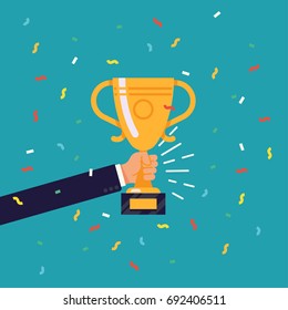 Creative flat design vector concept on businessman hand holding gold cup award icon. Winner prize goblet. Success and business achievements concept with award cup and confetti