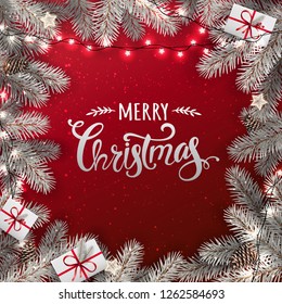 Creative frame made of snowy Christmas fir branches. Silver Merry Christmas text on red background with lights, pine cones. Xmas and New Year card. Vector Illustration
