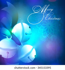 Creative glossy Jingle Bells with blue ribbon on shiny floral decorated background for Merry Christmas celebration.
